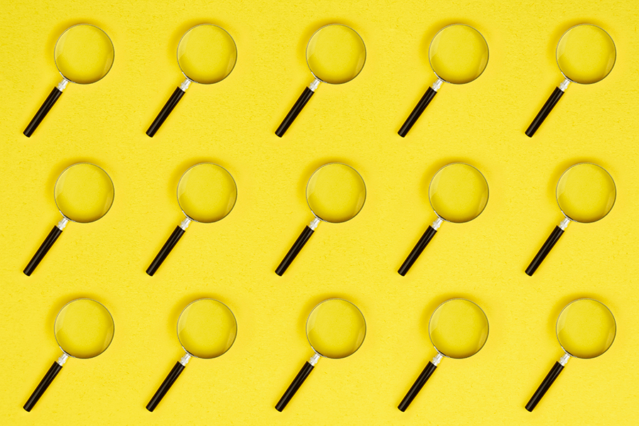 yellow background with a bunch of magnifying glasses