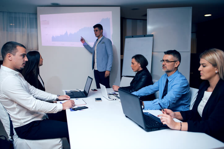 Businessman Leading Meeting At Boardroom Table